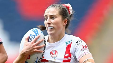 St Helens' Phoebe Hook runs with the ball