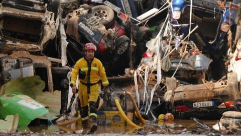 Members of the fire brigade, which are part of a search and rescue unit, carry out work as cars and debris block a tunnel after the recent flash flooding in the nearby municipality Benetusser on November 1, 2024 in the Benetusser municipality of Valencia, Spain