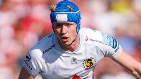 Josh Hodge in action for Exeter, wearing a blue headguard