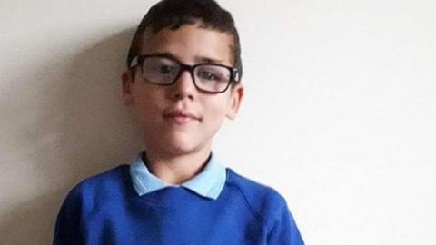 An image of Alfie Steele wearing a blue shirt and jumper