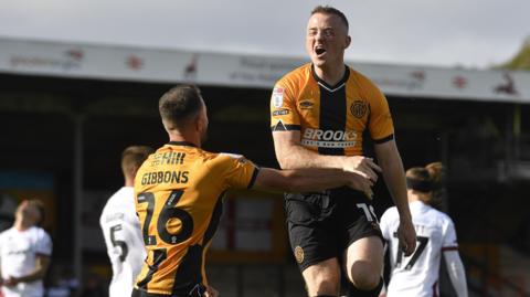 Shayne Lavery jumps in the air towards team-mate James Gibbons