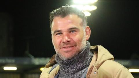 Mike Phillips, pictured with stubble and wearing a grey roll neck jumper and brown coat, has been banned from driving