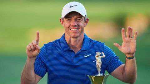 Rory McIlroy holds up six fingers to indicate his number of Race to Dubai victories