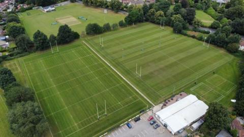 Drone picture showing four rugby pitches flanked by trees