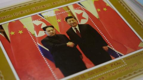 A commemorative stamp featuring North Korean leader Kim Jong-Un (L) meeting with China's leader Xi Jinping is pictured at a shop in Pyongyang on June 18, 2019.