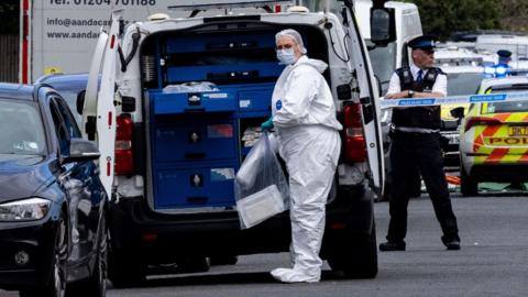 Forensic officers at the scene in Hart Street in Southport