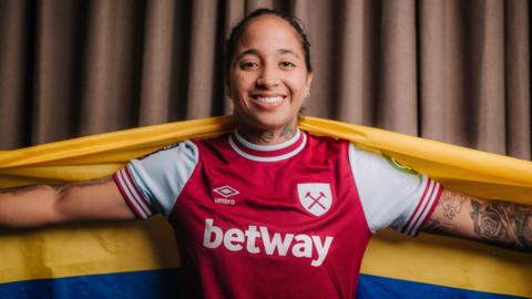 West Ham striker Manuela Pavi poses with Colombia flag after signing for the club