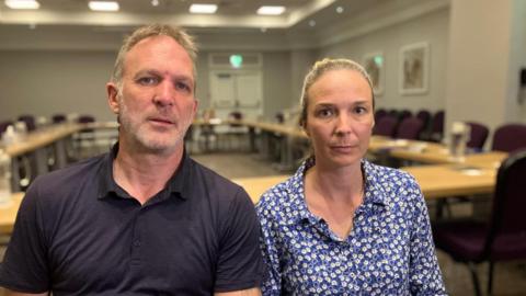 Jack and Sarah Hawkins are pictured sat next to each other