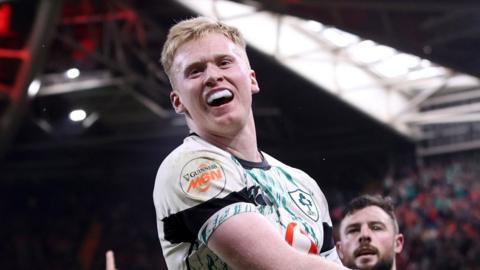 Jamie Osborne celebrates scoring a try against Wales