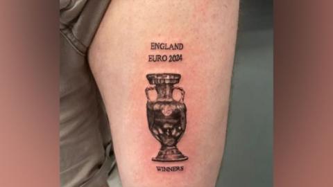 A tattoo of a trophy, with the words "England Euro 2024 Winners" around it