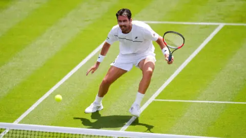 Cameron Norrie hits a forehand