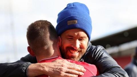 Paul Mullin embraces Wrexham co-owner Ryan Reynolds 