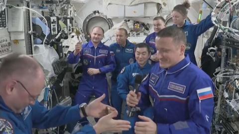 Space station commander Mike Fincke is seen giving the key to the station to Sergey Kud-Sverchkov.
