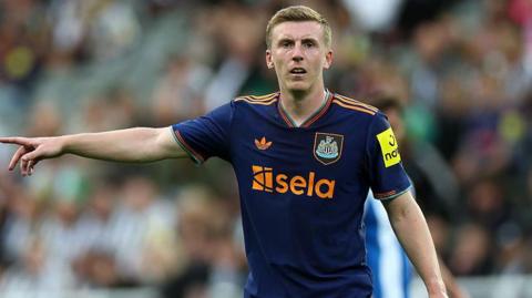 Matt Targett makes a point in action for Newcastle last season