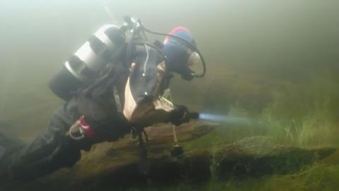 A diver explores beneath the loch.