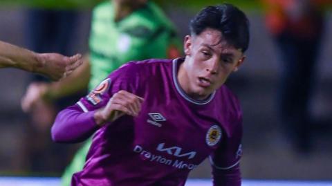 Frankie Maguire playing for Boston in a purple away kit during an evening game