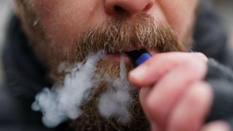 A man using a disposable vape