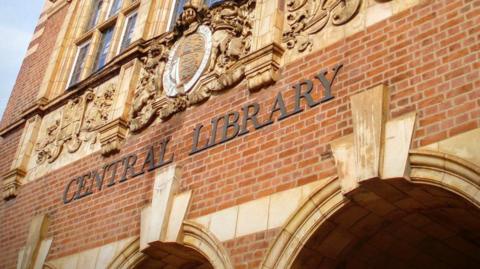 A building with the words Central Library on bricks. Windows are visible at the top of the photo.