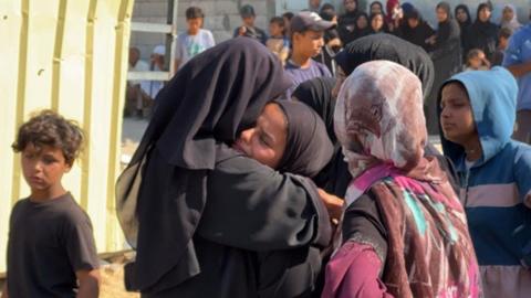 Mary Sheikh al-Eid's family is comforted after her body is brought to Nasser Hospital in Khan Younis, southern Gaza (24 July 2025) 