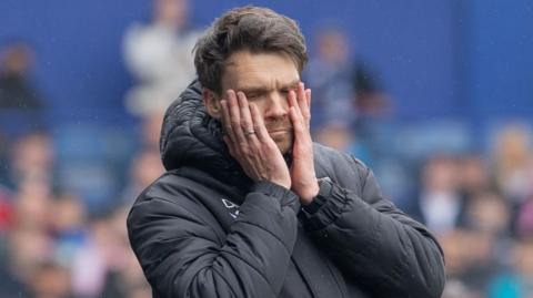 Danny Rohl covers his face with his hands