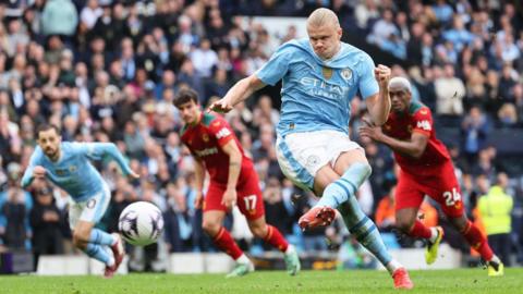 Erling Haaland of Manchester City scores his team's third goal from the penalty spot