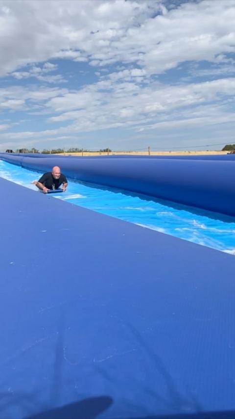 A man uses the slip and slide