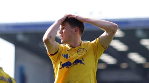 Leeds United's Sam Byram with his hands on his head after a chance is missed