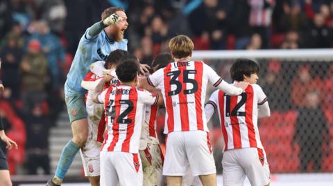 Stoke players celebrate Lewis Baker's late goal