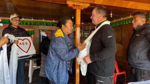 CPR campaigner David Sullivan pictured in Nepal where he installed a defibrillator on Mount Everest. The AED can be seen in the background of the image.