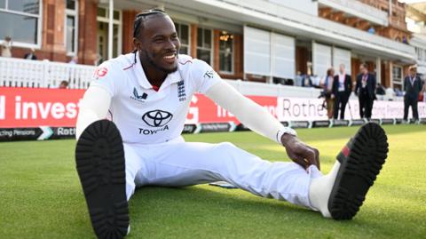 England fast bowler Jofra Archer sits in front of the Lord's pavilion after victory over India