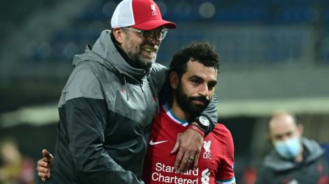 Liverpool boss Jurgen Klopp (left) embraces Mohamed Salah (right) after a Champions League match