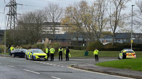 Police officers and police cars gathered at the junction of two roads in Winnersh on Wednesday morning.