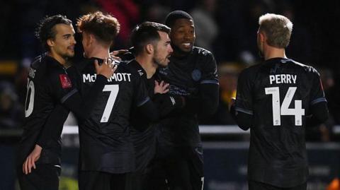 Shrewsbury players celebrate John Marquis' goal which gave them the lead at Sutton
