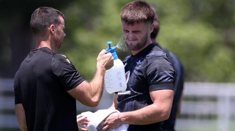 Wales centre Joe Roberts is kept refreshed during training with water squirted in his face