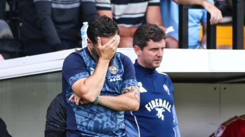 Notts County boss Martin Paterson with his hand on his head in frustration.