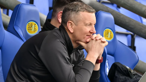 Cornwall RLFC coach Mike Abbott sitting in the dugout