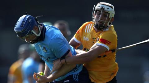 Antrim's Seaan Elliott tackles Conor Burke of Dublin