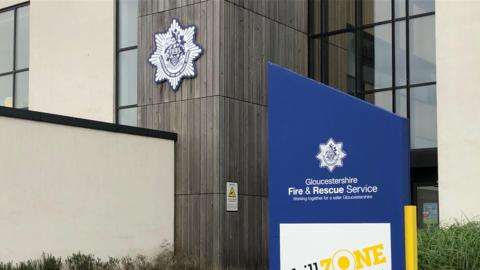 The Gloucestershire Fire and Rescue sign at the entrance to the building