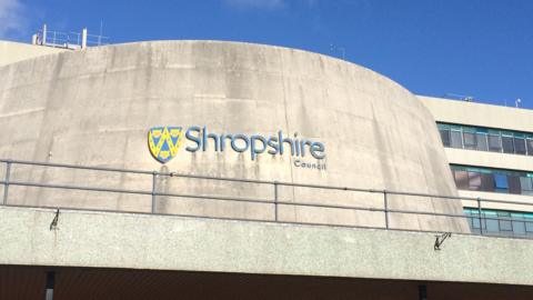 The front of a concrete building with a Shropshire Council logo on it