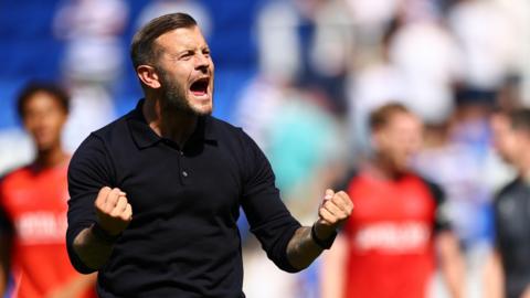 Luton manager Jack Wilshire pumps his fists in celebration after his side win 4-3 at Reading