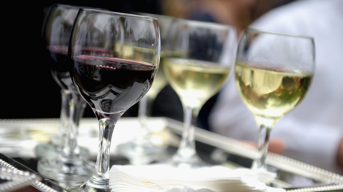 A general view of some glasses of wine on a tray, with red and white varieties