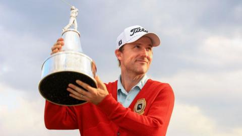 Russell Henley holds the Arnold Palmer Invitational trophy