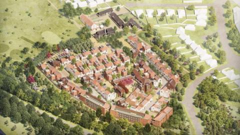 An artists impression drawing from above of the proposed housing development. It shows dozens of homes with terracotta roofs surrounded by trees.