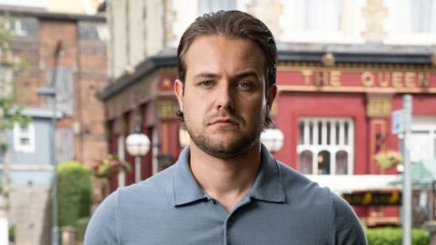 Actor Matthew James-Bailey stands in front of the Queen Vic pub in Albert Square