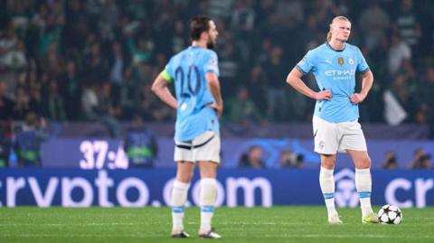 Erling Haaland and Bernardo Silva of Manchester City react after Viktor Gyokeres of Sporting CP scores his team's first goal during the UEFA Champions League match between Sporting CP and Manchester City at Jose Alvalade Stadium