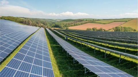 An image of an existing solar farm owned by BSR. Long rows of flat solar panels run across fields

