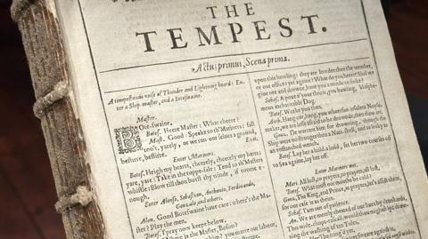 Close up of the front of the book, which is a page with the play The Tempest beginning on it