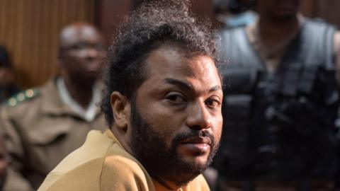  Thabo Bester, in a yellow top, is see seated at the Bloemfontein Magistrate's Court in South Africa on 14 April 2023 