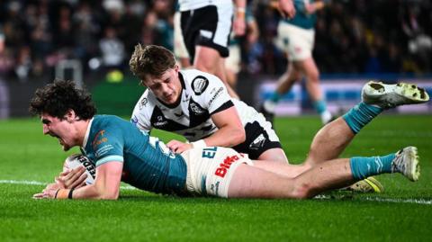 Jake Davies roars with delight after diving over the line to ground the ball for his first Super League try