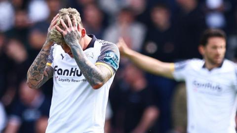 Derby County's Sam Szmodics has his hands in his head with despair 